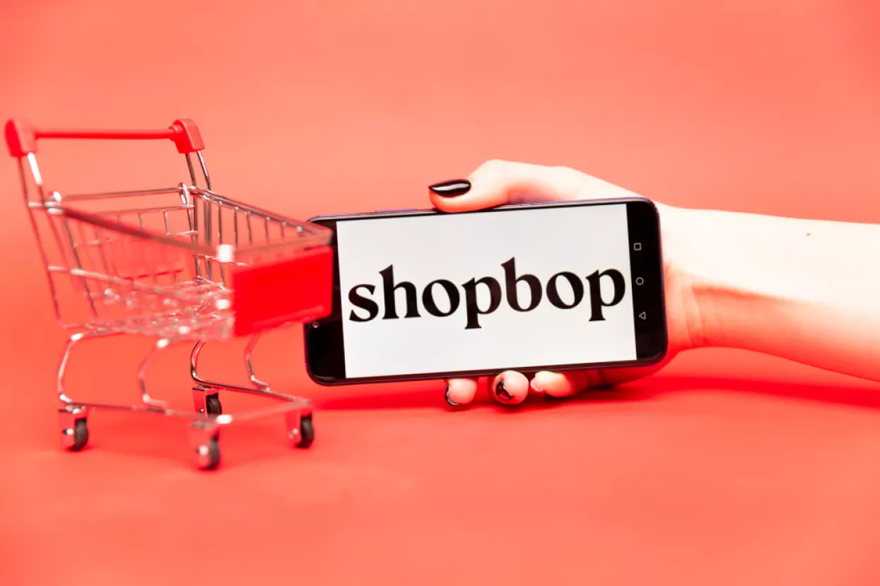 Tula<br>Shopbop on the phone display. Logo<br>webshop