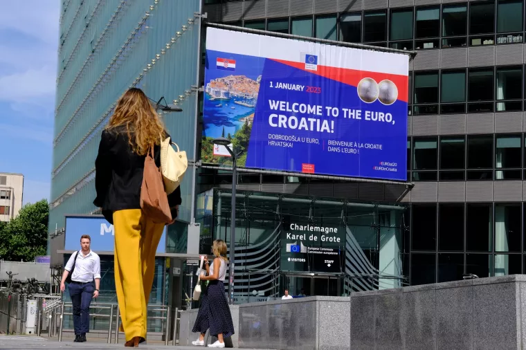 A banner welcoming Croatia to the euro seen in front of EU headquarters in Brussels, Belgium on July 12, 2022. The EU removes the final obstacles for Croatia to adopt the euro.