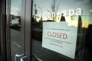 Kirkland, Washington/USA - March 19 2020Closed sign in the storefront of a hair salon during the COVID-19 pandemic