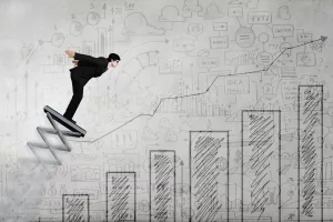 Businessman jumping on springboard as progress concept