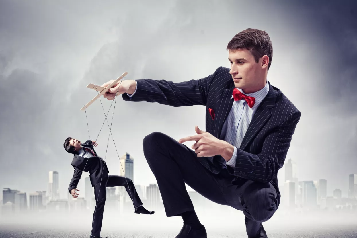 Image of young businessman puppeteer. Leadership concept