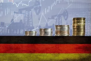 Coins on top of the flag of Germany on the background of oil rigs and charts. Concept - increase in the cost of gasoline, diesel, energy in Germany. Increase in the selling price of hydrocarbons.<br>njemačka, inflacija, rast cijena, troškovi, porast troškova, industrija, proizvodnja