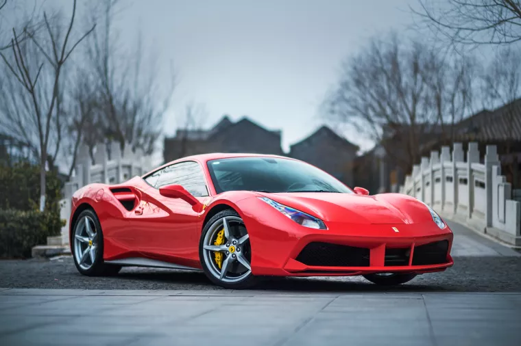 TIANJIN, CHINA - FEB 27, 2016A red Ferrari 488 GTB parked in front of a stone bridge. The Ferrari 488 is an Italian sports car produced since 2015, powered by a 3.9-litre twin-turbocharged V8.