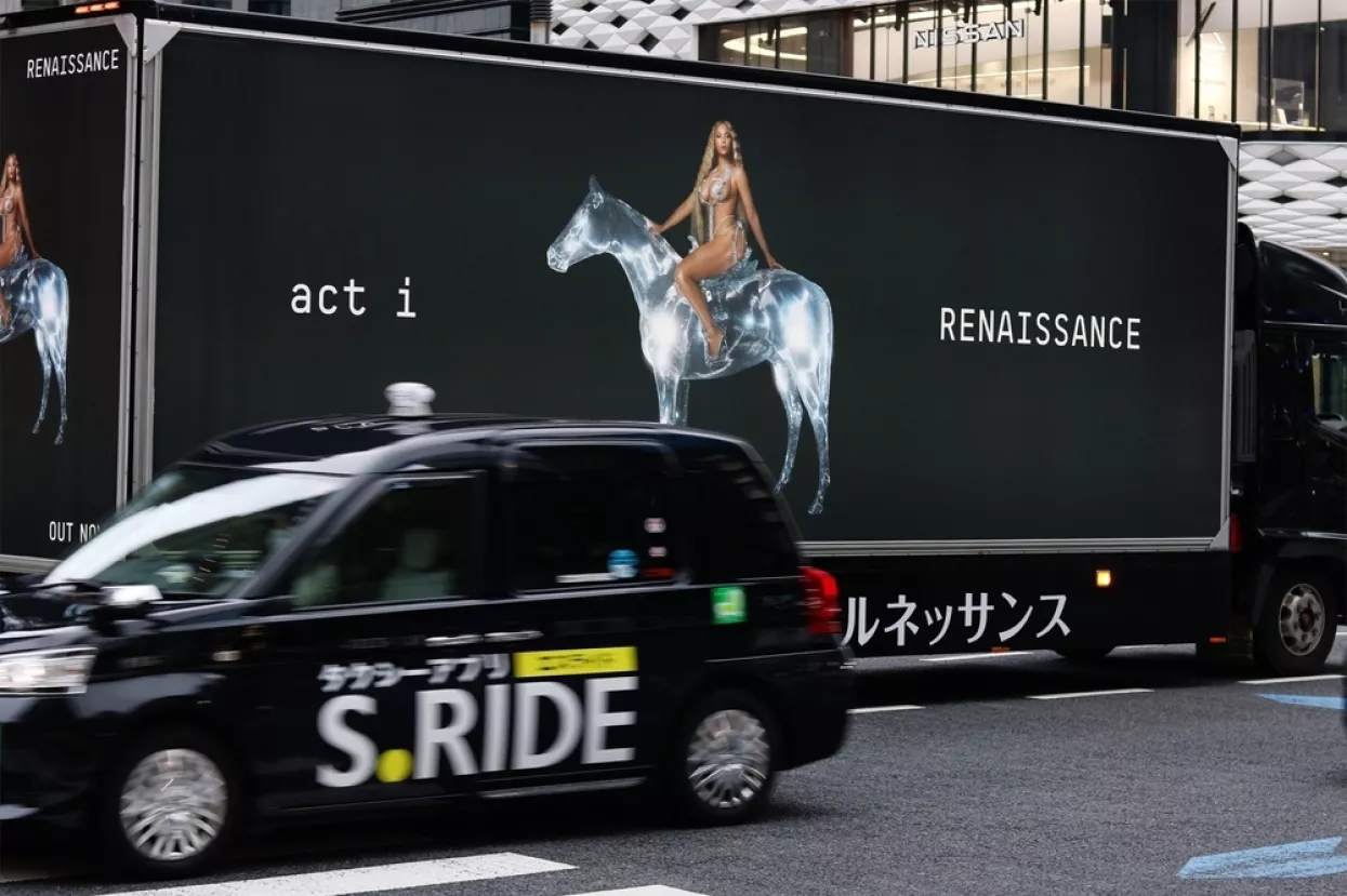 TOKYO, JAPAN - August 4, 2022A taxi passes a large advertising truck promoting Beyonce's new album in Tokyo's Ginza area. Ginza Place is in the background. Some motion blur. Renaissance