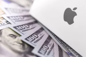 Apple logo on box, dollars. Apple is a multinational technology company that designs, develops, sells electronics, computer software, online services. Ekaterinburg, Russia - February 28, 2018