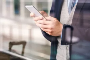 Double exposure of a handsome young man with smart phone