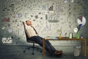 Mature business man relaxing at his desk in his office