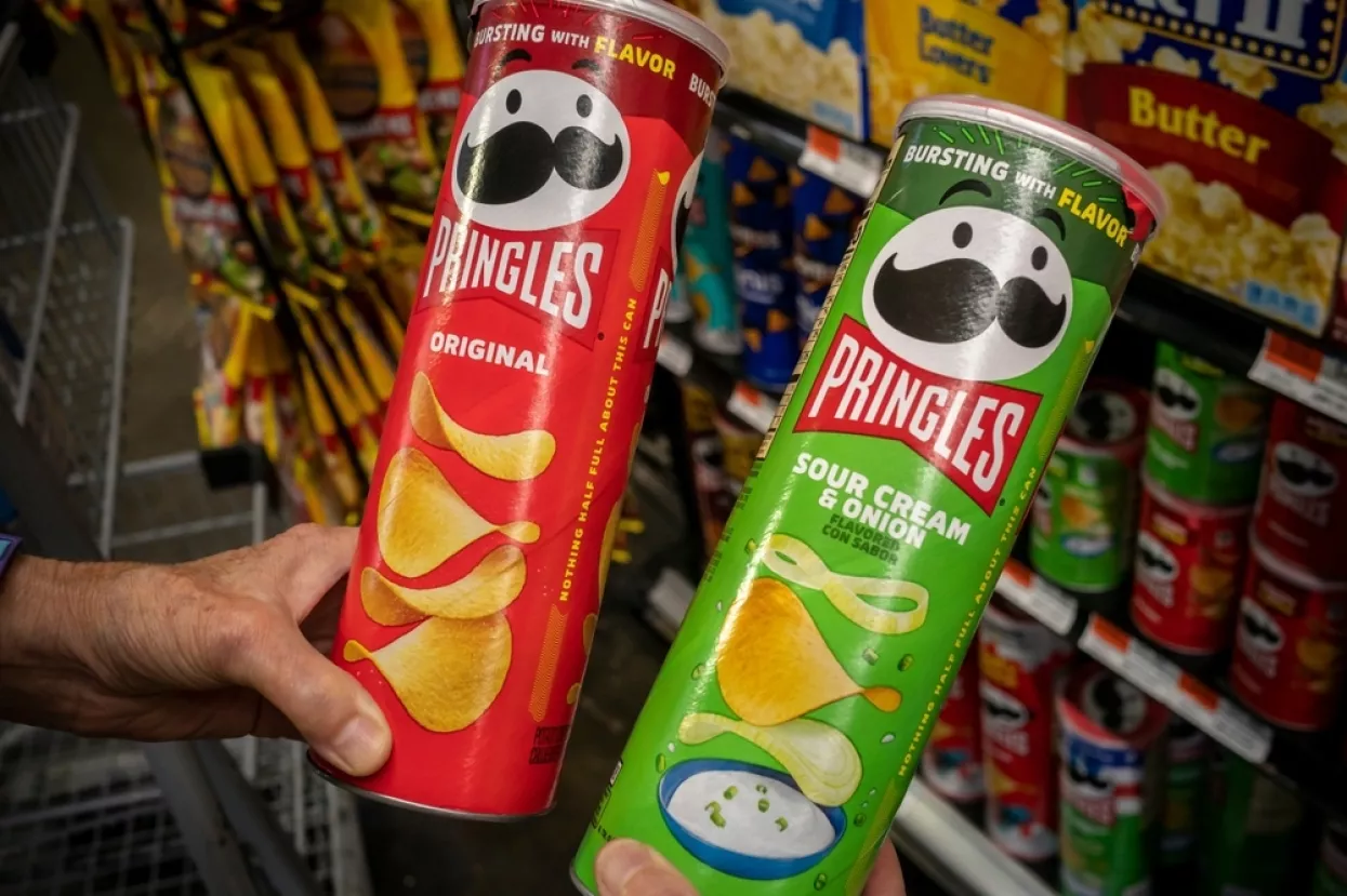 New York NY USA-August 5, 2024 A shopper chooses cans of Pringles in a supermarket in New York