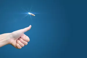 hand throws a coin on a blue background to make the decision