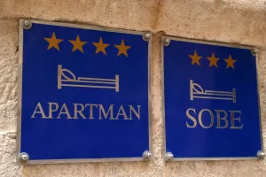 Dubrovnik, Croatia, october 25, 2023 Signs indicating apartment and room rental in Croatian languageapartmani, sobe, soba, renta, rentijerstvo, rentijeri, najam apartmana, turizam