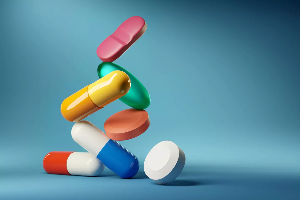 Medical balancing act. A group of medicine pills and antibiotics balacning on top of each other. 3D render illustration.lijekovi, tablete, kapsule