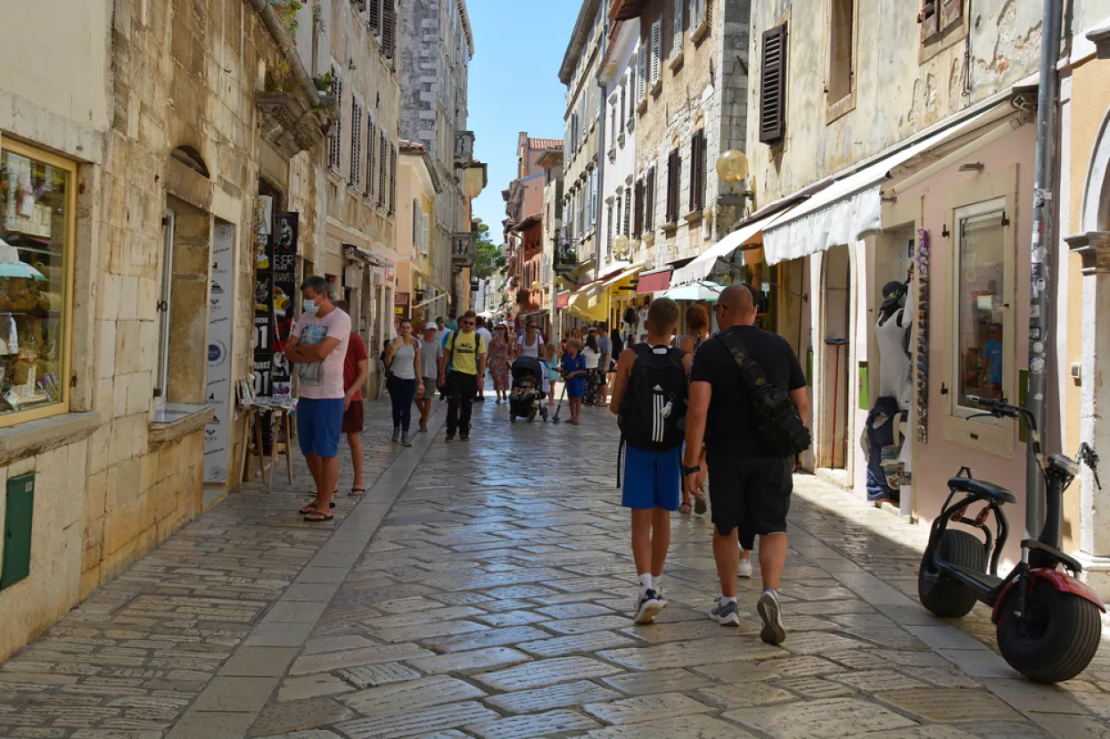 Porec, Croatia- July 10th 2021. A street busy with shops and tourists in the historic medieval coastal town of Porec in Istria, CroatiaPoreč, turizam Hrvatska, Dekumanova